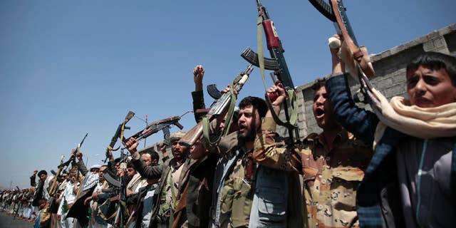 FILE - In this Oct. 2, 2016 file photo, tribesmen loyal to Houthi rebels, hold their weapons as they chant slogans during a gathering aimed at mobilizing more fighters into battlefronts in several Yemeni cities, in Sanaa, Yemen. The U.S. is weighing what military response it should take against Yemen-based Houthi rebels, who U.S. officials say launched two missiles at American warships in the Red Sea on Sunday, the Pentagon said Tuesday, Oct. 11, 2016.  (AP Photo/Hani Mohammed, File)
