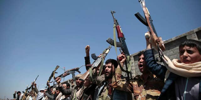 FILE - In this Oct. 2, 2016 file photo, tribesmen loyal to Houthi rebels, hold their weapons as they chant slogans during a gathering aimed at mobilizing more fighters into battlefronts in several Yemeni cities, in Sanaa, Yemen. The U.S. is weighing what military response it should take against Yemen-based Houthi rebels, who U.S. officials say launched two missiles at American warships in the Red Sea on Sunday, the Pentagon said Tuesday, Oct. 11, 2016. (AP Photo/Hani Mohammed, File)