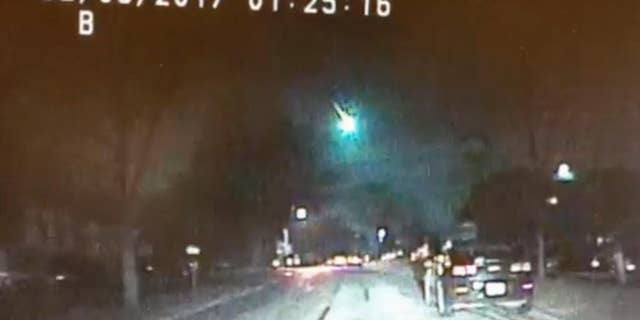 This image from a dashcam video provided by the Lisle Police Department in Lisle, Ill., shows a meteor as it streaked over Lake Michigan early Monday morning, Feb. 6, 2017. The meteor lit up the sky across several states in the Midwest. (Lisle (Ill.) Police Department via AP)