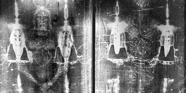 Full-length negative photograph of the Shroud of Turin.