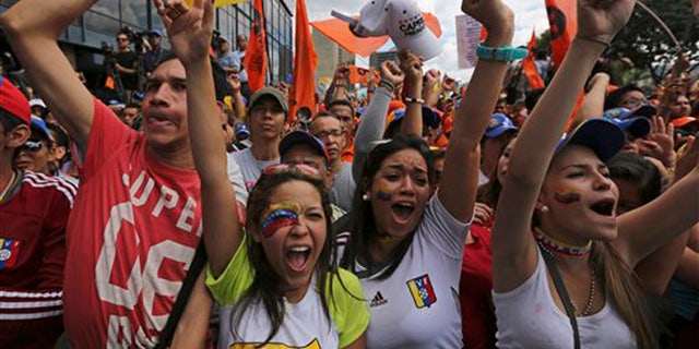 Supporters of opposition leader Henrique Capriles greet him upon his arrival to lead a protest against Venezuela's President Nicolas Maduro in Caracas, Venezuela, Saturday, Nov. 23, 2013. Thousands of Maduro opponents took to the streets on Saturday to express outrage over the countryÃs deepening economic crisis, seeking to rebuild momentum sapped after a string of electoral defeats. (AP Photo/Fernando Llano)
