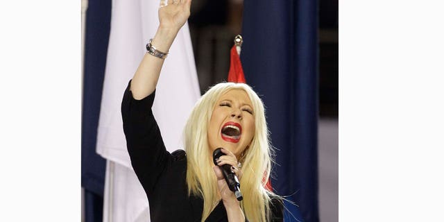 Christina Aguilera sings the national anthem before the NFL football Super Bowl XLV game between withe Green Bay Packers and the Pittsburgh Steelers Sunday, Feb. 6, 2011, in Arlington, Texas. (AP Photo/Charlie Krupa)