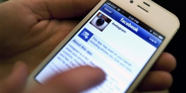 An Instagram photo is shared with Facebook on an iPhone.