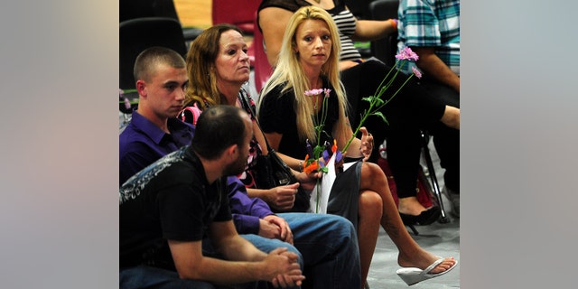 Family members of Hailey Darlene Dunn, including her mother, Billie Jean Dunn, right, grieve the teenager's loss during a public memorial service Sunday at Colorado Middle School in Colorado City, Texas. (AP Photo/The Abilene Reporter-News, Joy Lewis)