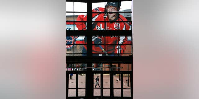 A large photo of Washington Capitals captain and All-Star Alex Ovechkin adorns the windows above and entrance to the Nationwide Arena for the NHL All-Star hockey weekend in Columbus, Ohio, Friday, Jan. 23, 2015. (AP Photo/Gene J. Puskar