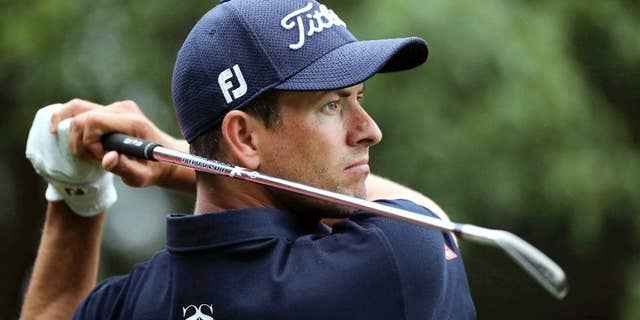 FILE - In this Oct. 27, 2016, file photo, Adam Scott of Australia hits the ball from a sand bank during the WGC-HSBC Champions golf tournament at the Sheshan International Golf Club in Shanghai, China. On Friday, Scott put together back-to-back rounds of 68 and feels like he's really back in the swing of things as he heads into the weekend at the Australian PGA Championship four shots off the pace. (AP Photo/Ng Han Guan, File)