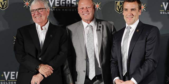 FILE - In this April 13, 2017, file photo, Vegas Golden Knights coach Gerard Gallant is flanked by Bill Foley, left, owner of the Vegas Golden Knights, and George McPhee, Vegas Golden Knights general manager, in Las Vegas. Vegas Golden Knights general manager George McPhee certainly wouldn't mind some Lady Luck to rub off on his NHL expansion franchise when it comes to how the balls drop in the league's draft lottery on Saturday. (AP Photo/John Locher, File)