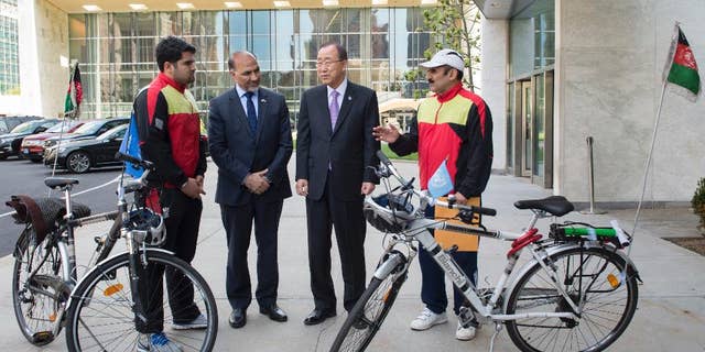 In this photo provided by the United Nations, United Nations Secretary General Ban Ki-moon, center-right, meets with Nader Shah Nangarhari, right, and his son Firoz Khan, left, on the grounds of United Nations headquarters, Friday, May 20, 2016. The father and son team are on a round-the-world trip to promote peace. At center-left is Afghan ambassador to the United Nations, Mahmoud Saikal. (Eskinder Debebe/The United Nations via AP)