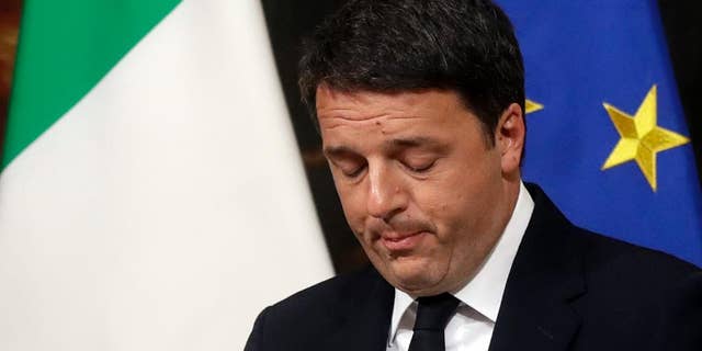 Italian Premier Matteo Renzi speaks during a press conference at the premier's office Chigi Palace in Rome, early Monday, Dec. 5, 2016. Renzi acknowledged defeat in a constitutional referendum and announced he will resign on Monday. Italians voted Sunday in a referendum on constitutional reforms that Premier Matteo Renzi has staked his political future on. (AP Photo/Gregorio Borgia)