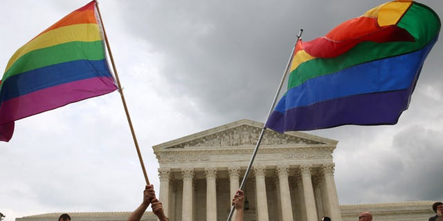 WASHINGTON, DC - JUNE 26: People celebrate in front of the U.S. Supreme Court after the ruling in favor of same-sex marriage June 26, 2015 in Washington, DC. The high court ruled that same-sex couples have the right to marry in all 50 states. (Photo by Mark Wilson/Getty Images)