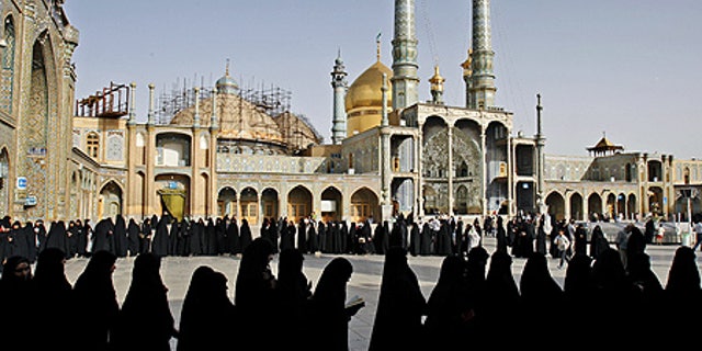 June 12: Iranian women stand in line to cast their votes at Masoumeh shrine in Qum, south of Tehran, Iran.