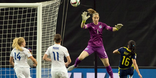 Colombia's Lady Andrade scores on England's goalkeeper Karen Bardsley as England's Alex Greenwood, left, and Jode Moore look on during the second half of a FIFA Women's World Cup soccer match, Wednesday, June 17, 2015, in Montreal, Canada. (Ryan Remiorz/The Canadian Press via AP) MANDATORY CREDIT