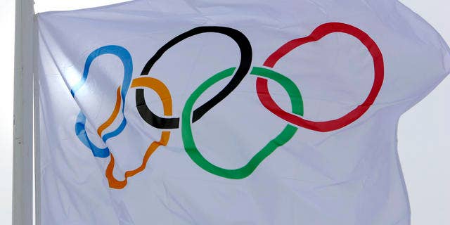 The Olympic flag flutters in the wind after the Nordic Combined team competition at the Turin 2006 Winter Olympic Games had to be cancelled due to the strong wind in Pragelato Plan, Italy, Wednesday, Feb 15, 2006. (AP Photo/Jens Meyer)