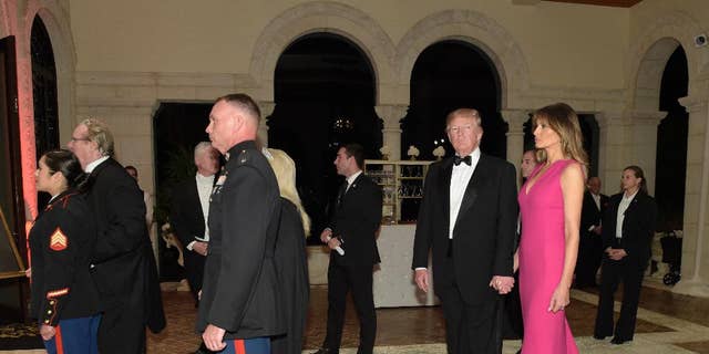 President Donald Trump and first lady Melania Trump arrive for the 60th annual Red Cross Gala at Trump's Mar-a-Lago resort in Palm Beach, Fla., Saturday, Feb. 4, 2017. (AP Photo/Susan Walsh)