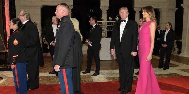 President Donald Trump and first lady Melania Trump arrive for the 60th annual Red Cross Gala at Trump's Mar-a-Lago resort in Palm Beach, Fla., Saturday, Feb. 4, 2017. (AP Photo/Susan Walsh)