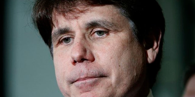 In this June 9 photo, former Illinois Gov. Rod Blagojevich pauses as he talks with reporters at the Federal Court building in Chicago.
