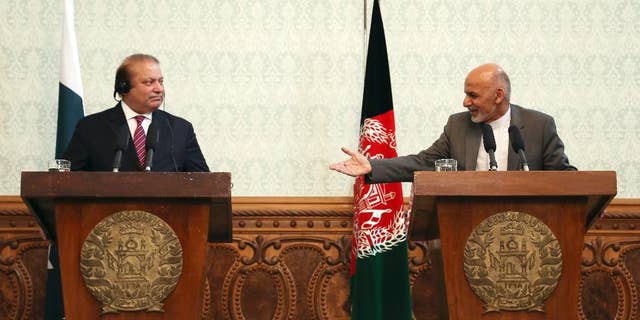 FILE - In a May 12, 2015 file photo, Afghan President Ashraf Ghani, right, speaks as Pakistani Prime Minister Nawaz Sharif listens during a joint press conference at the presidential palace in Kabul, Afghanistan. Pakistan said Wednesday, July 8, 2015, that the first official face-to-face discussions between Afghan government officials and the Taliban have made progress, with the two sides agreeing at a meeting near Islamabad to work on confidence-building measures and hold more such talks after the Muslim holy month of Ramadan. (AP Photo/Rahmat Gul, File)