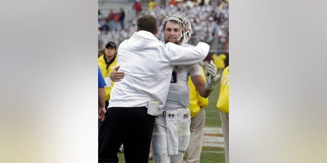Maryland quarterback C.J. Brown, right, gets a hug from head coach Randy Edsall after their 27-24 win over Virginia Tech in an NCAA college football game in Blacksburg, Va., Saturday, Nov. 16, 2013. (AP Photo/Steve Helber)