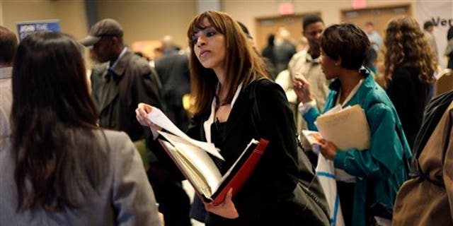 April 18, 2011: A woman at a job fair in New York talks to an employer.  (AP Photo/Seth Wenig, File)