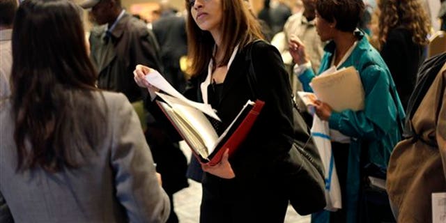 April 18, 2011: A woman at a job fair in New York talks to an employer. (AP Photo/Seth Wenig, File)