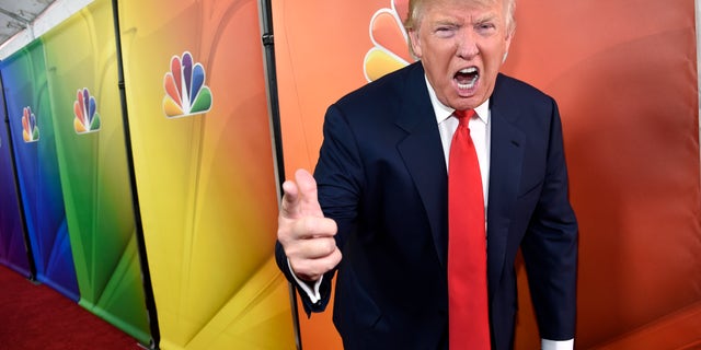 FILE - In this Jan. 16, 2015 file photo, Donald Trump, host of the television series "The Celebrity Apprentice," mugs for photographers at the NBC 2015 Winter TCA Press Tour in Pasadena, Calif. NBC on Monday, June 29, 2015 said that it is ending its business relationship with Trump, now a Republican presidential candidate, because of comments he made about immigrants during the announcement of his campaign. (Photo by Chris Pizzello/Invision/AP, File)