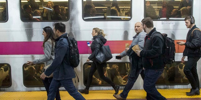 Evening rush hour commuters look to board their New Jersey Transit train at Penn Station, Friday, March 24, 2017, in New York. Commuters to both New Jersey and Long Island faced a difficult journey home Friday evening after two passenger trains clipped each other during the morning rush at Penn Station, jolting riders and creating major travel disruptions but causing no serious injuries. (AP Photo/Mary Altaffer)