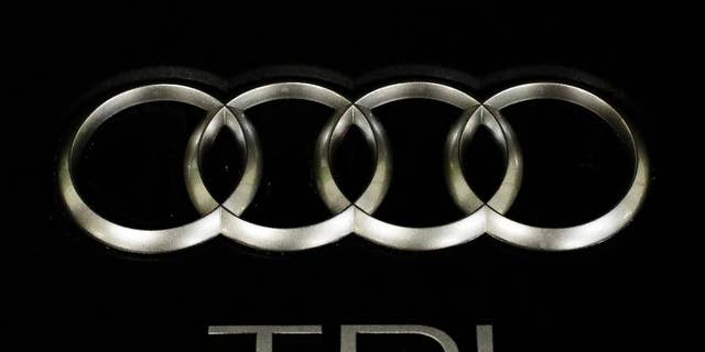 The sign of German car company Audi is attached on the engine of a TDI, a turbo diesel model, in Berlin, Germany, Monday, Sept. 28, 2015. Volkswagen AG's upmarket Audi brand said 2.1 million of its vehicles are among those with the engines affected by the emissions-rigging scandal. (AP Photo/Markus Schreiber)