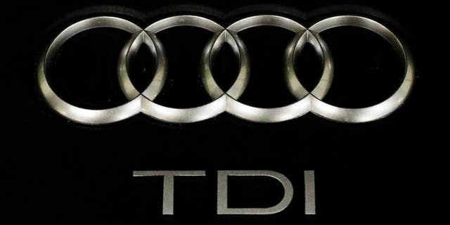 The sign of German car company Audi is attached on the engine of a TDI, a turbo diesel model, in Berlin, Germany, Monday, Sept. 28, 2015. Volkswagen AG's upmarket Audi brand said 2.1 million of its vehicles are among those with the engines affected by the emissions-rigging scandal. (AP Photo/Markus Schreiber)