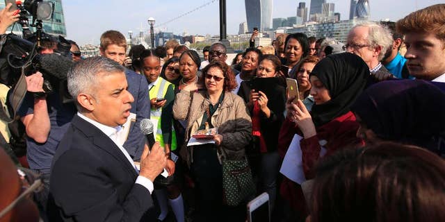 Newly elected London's mayor Sadiq Khan speaks to the media and well wishers outside City Hall in London, on his first day as mayor, Monday May 9, 2016. (Jonathan Brady/PA via AP) UNITED KINGDOM OUT