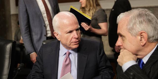 Senate Armed Services Committee Chairman Sen. John McCain, R-Ariz., left, confers with the committee's ranking member, Sen. Jack Reed, D-R.I., on Capitol Hill in Washington, Tuesday, March, 14, 2017, prior to the start of the committee's hearing on the investigation of nude photographs of female Marines and other women that were shared on the Facebook page "Marines United." (AP Photo/J. Scott Applewhite)