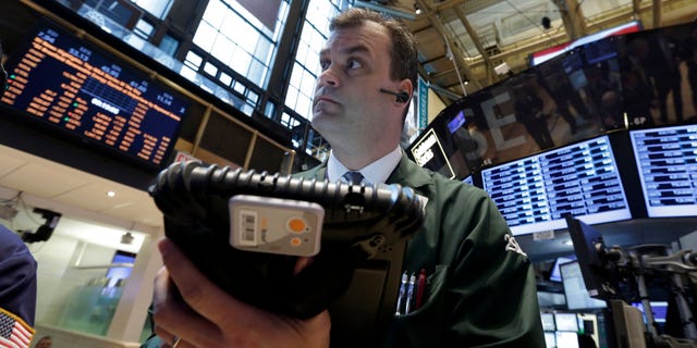 In this Tuesday, Feb. 26, 2013, photo, Trader William Lawrence works on the floor of the New York Stock Exchange.Futures are rising as Chairman Ben Bernanke heads to Capitol Hill to explain what the Federal Reserve will do to accelerate the economic recovery. (AP Photo/Richard Drew)