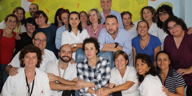 This Nov. 1, 2014 photo provided by the Madridâs Carlos III hospital shows Teresa Romero, center, posing for a photo with medical workers and friends after leaving the isolation unit in the Carlos III hospital in Madrid, Spain. Hospital officials say a Spanish nursing assistant who recovered from an Ebola virus infection has left the isolation unit where she was being monitored and moved to a normal room. Teresa Romero tested positive on Oct 6, but was declared cured of the virus 15 days later. She was the first known person to contract the disease outside of West Africa in the latest outbreak. Madridâs Carlos III hospital said Saturday that Romero, 44, was now being attended by hospital staff that no longer needed to wear protective outfits. (AP Photo)