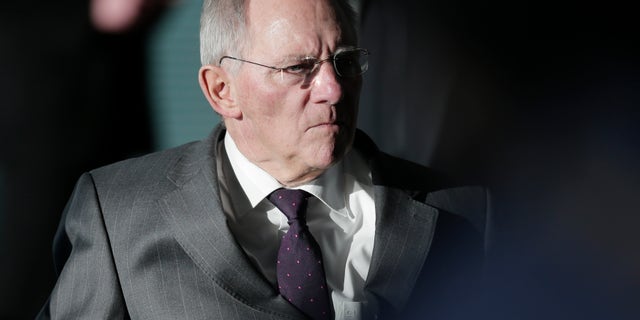 German Finance Minister Wolfgang Schaeuble arrives for the weekly cabinet meeting at the chancellery in Berlin, Germany, Wednesday, Feb. 6, 2013. The cabinet will discuss a new national law for bank regulations. (AP Photo/Markus Schreiber)