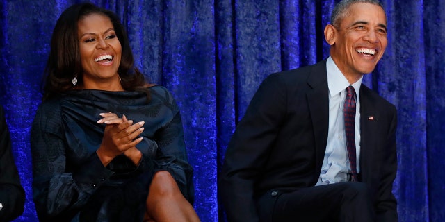 Former U.S. President Barack Obama sits with former first lady Michelle Obama prior during the unveiling of their portraits at the Smithsonian’s National Portrait Gallery in Washington, U.S., February 12, 2018.