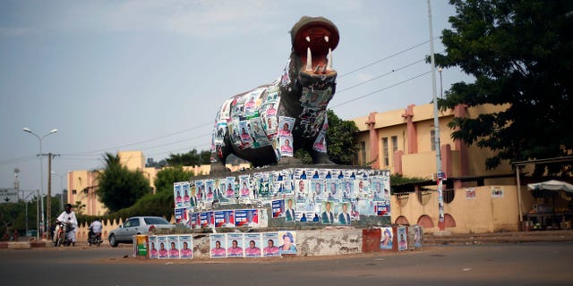 A statue of a hippopotamus is covered with election posters at a traffic circle in Bamako, Mali, Tuesday Nov. 19, 2013. Mali is scheduled to hold parliamentary elections on Sunday, Nov. 24, 2013, in an effort to finalize a return to democracy after a 2012 military coup. Last week residents reported an increase in armed Tuareg rebels in the northern Mali town of Kidal, underscoring the security risks that remain even after a French-led military intervention ousted al-Qaida-linked militants from the major towns in the region. (AP Photo/Jerome Delay)