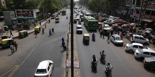 Few vehicles are seen plying on the otherwise severely busy Mehrauli Badarpur road during rush hour in New Delhi, India, Friday, April 15, 2016. The New Delhi government has begun a second round of a two-week car restriction whereby private cars will be allowed on the streets on alternate days from Friday until April 30 based on even or odd license plate numbers, to reduce air pollution that has made the Indian capital the world's most polluted city. (AP Photo/Saurabh Das)