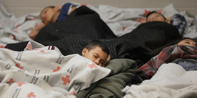 June 18, 2014: Children detainees sleep in a holding cell at a U.S. Customs and Border Protection processing facility in Brownsville, Texas. (AP)
