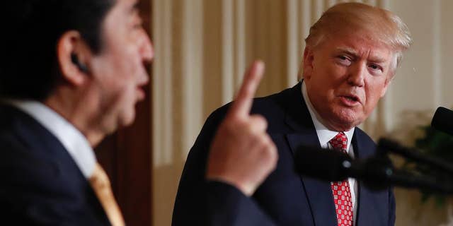 President Donald Trump listens Japanese Prime Minister Shinzo Abe speaks during a joint new conference in the East Room of the White House, in Washington, Friday, Feb. 10, 2017. (AP Photo/Carolyn Kaster)