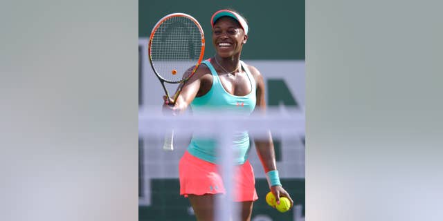 Sloane Stephens smiles prior to serving to Flavia Pennetta, of Italy, during a quarterfinal match at the BNP Paribas Open tennis tournament, Thursday, March 13, 2014, in Indian Wells, Calif. (AP Photo/Mark J. Terrill)