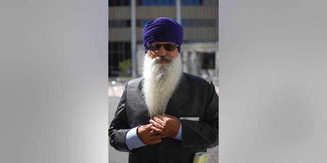 This May 12, 2015, photo provided by the Sikh Coalition shows Lakhbir Singh, one of the four truckers in the case against J.B. Hunt Transportation Services Inc., taken at the Los Angeles Equal Employment Opportunity Commission office during conciliation in Los Angeles. Four Sikh truckers who could not comply with drug testing that required them to provide clipped hair samples or remove their turban because those violate religious principles reach a settlement with a major national trucking company. (Simran Kaur/The Sikh Coalition via AP)