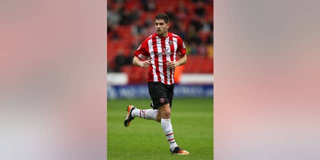 FILE - This March 17, 2013 file photo of footballer Ched Evans at Sheffield United. The former Premier League footballer who was convicted of rape has been told he can resume training with third tier club Sheffield United amid a national debate about the decision. (AP Photo/Nick Potts, PA) UNITED KINGDOM OUT