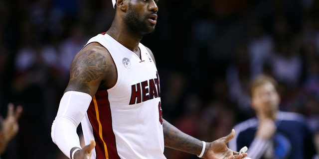 Miami Heat's LeBron James argues he was fouled by a Dallas Mavericks player during the second half of an NBA basketball game in Miami, Wednesday, Jan. 2, 2013. The Heat won 119-109 in overtime. (AP Photo/J Pat Carter)