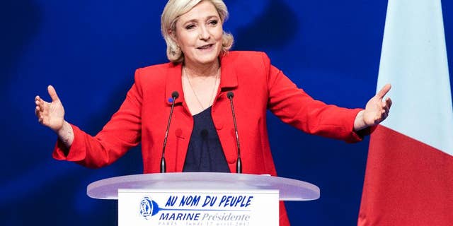 FILE - In this Monday, April 17, 2017 file photo, far-right candidate for the presidential election Marine Le Pen speaks during a campaign meeting in Paris. They could hardly be more different: Pro-European centrist Emmanuel Macron is facing anti-immigration, anti-EU Marine Le Pen in France’s presidential runoff May 7. (AP Photo/Kamil Zihnioglu, file)