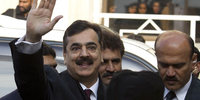 January 19, 2012: Pakistani Prime Minister Yousuf Raza Gilani waves upon his arrival at the Supreme Court in Islamabad.