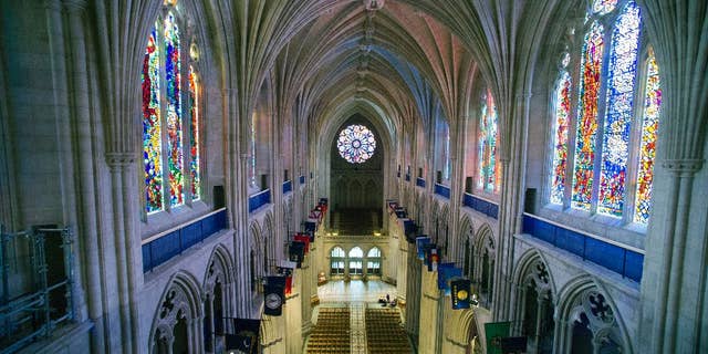 FILE - This Wednesday, Feb. 18, 2015 file photo shows the nave of the Washington National Cathedral in Washington. A day after Donald Trump is sworn in, he and his cabinet members plan to attend a prayer service at the cathedral where "all faiths will be represented at his request," according to the Washington Episcopal bishop who oversees the cathedral. But the customary ceremony is complicated this time by anger over the president-elect’s rhetoric on Muslims, immigrants and others. (AP Photo/Cliff Owen)