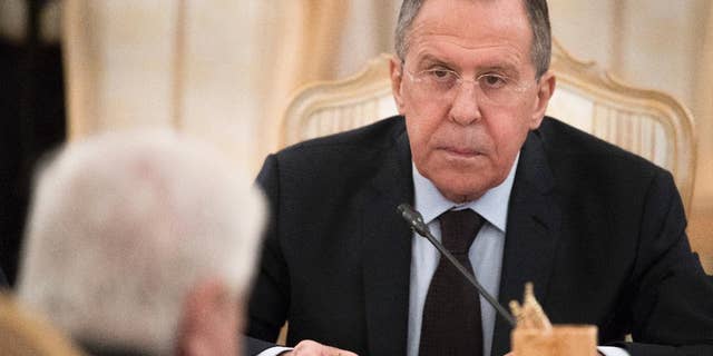 Russian Foreign Minister Sergey Lavrov listens to his Syrian counterpart Walid Muallem during their meeting in Moscow, Russia, on Thursday, April 13, 2017. Lavrov said he expected the OPCW ( Organization for the Prohibition of Chemical Weapons ) to conduct an extensive probe into the suspected nerve gas attack on Khan Sheikhoun, Syria, which could produce a report within about three weeks, the British delegation to the commission said Thursday. (AP Photo/Pavel Golovkin)