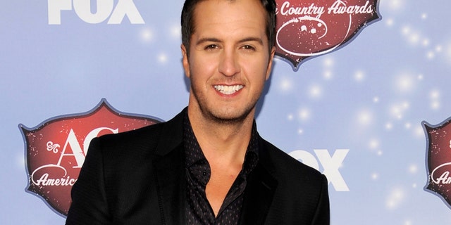 FILE - This Dec. 10, 2013 file photo shows Luke Bryan at the American Country Awards at the Mandalay Bay Resort & Casino in Las Vegas, Nev. Bryan announced the stadium shows in Pittsburgh in June and Philadelphia and Chicago in August during a news conference Tuesday, Jan 14, 2014. Bryan said he's stepping everything up as he heads into just his second headlining tour of about 80 dates. (Photo by Chris Pizzello/Invision/AP, File)