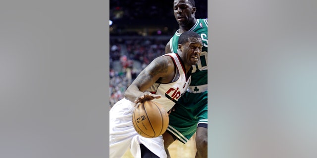 Portland Trail Blazers guard Wesley Matthews, left, drives the baseline against Boston Celtics forward Brandon Bass during the second half of an NBA basketball game in Portland, Ore., Sunday, Feb. 24, 2013. Matthews led the Trail Blazers in scoring with 24 points as they beat the Celtics 92-86.(AP Photo/Don Ryan)