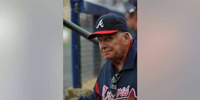 Former Atlanta Braves manager Bobby Cox watches from the dugout as he manages the minor league Future Stars against the Atlanta Braves in an exhibition baseball game Saturday, March 29, 2014, in Rome, Ga. (Associated Press)