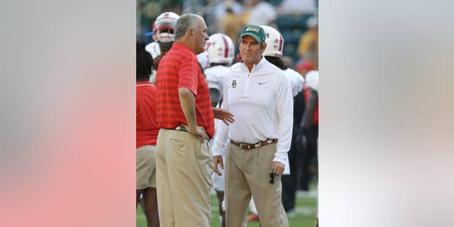 Baylor head coach Art Briles, right, and SMU head coach June Jones visit on the field before an NCAA college football game Sunday, Aug. 31, 2014, in Waco, Texas. (AP Photo/LM Otero)